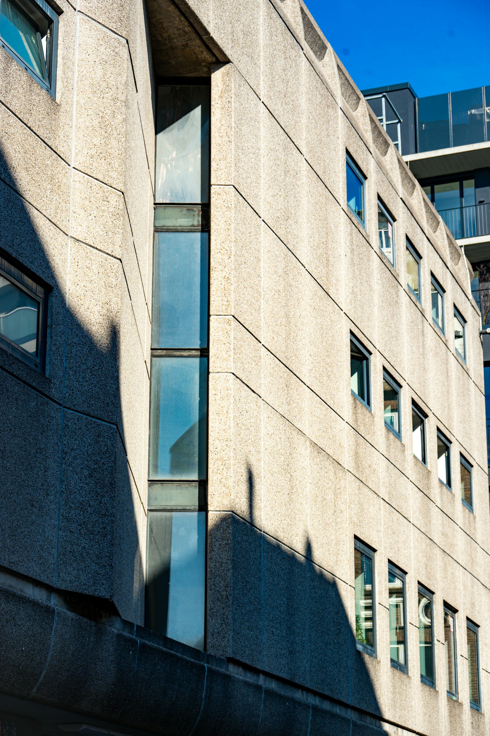 Sculptural stone architecture with precise lines and diagonal shadows